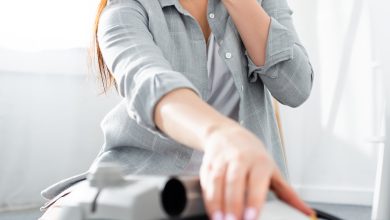 selective focus of allergic woman covering mouth with tissue and