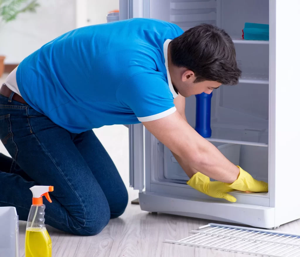 man cleaning fridge 1024x876